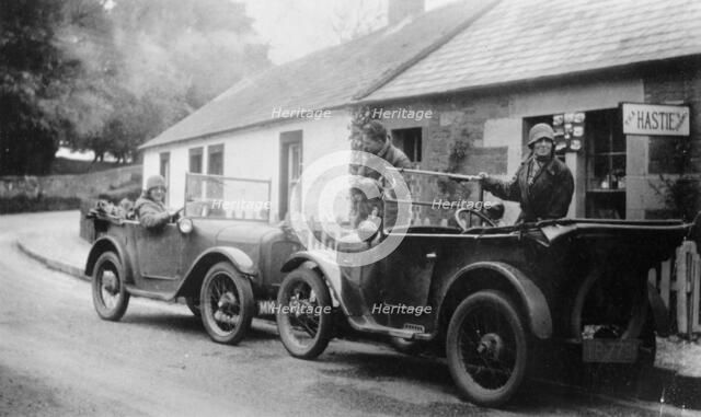 Two Austin Sevens parked outside a small tea shop, c1925. Artist: Unknown