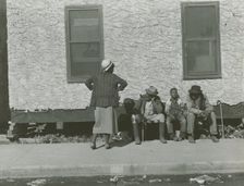 Two African American men and one African American boy sitting and one African..., Jan 1939. Creators: Farm Security Administration, Marion Post Wolcott