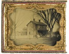 Two and a Half Story Brick Country House with Outbuildings with Ornate Porch..., 19th century. Creator: Unknown