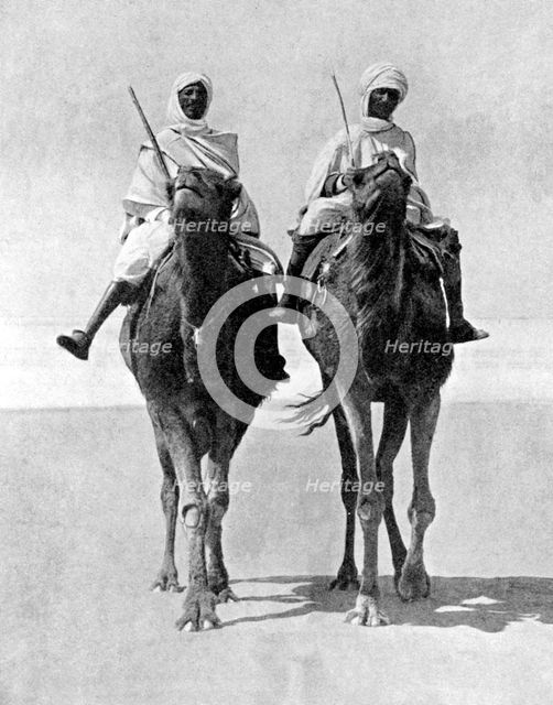 Two Arabs riding camels in the Sahara Desert, Africa, 1936.Artist: Fox Photos