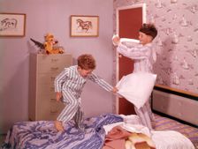 Two boys having a pillow fight, c1955. Creator: Arthur Charles Kirby Ware