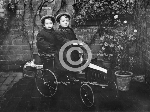 Two boys in a pedal car, (early 20th century?). Artist: Unknown