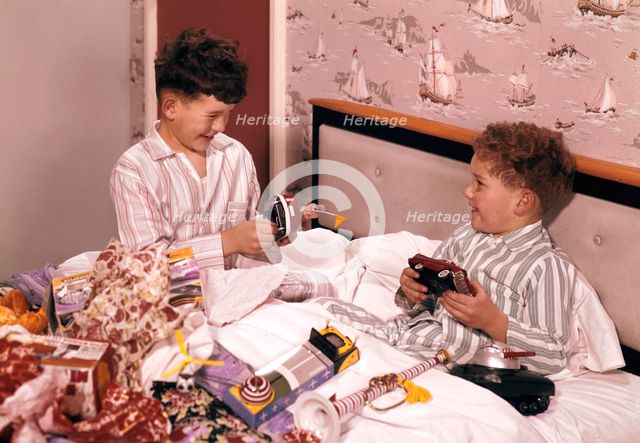 Two boys opening presents at Christmas, c1955-1965. Creator: Arthur Charles Kirby Ware.