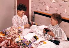 Two boys opening presents at Christmas, c1955-1965. Creator: Arthur Charles Kirby Ware