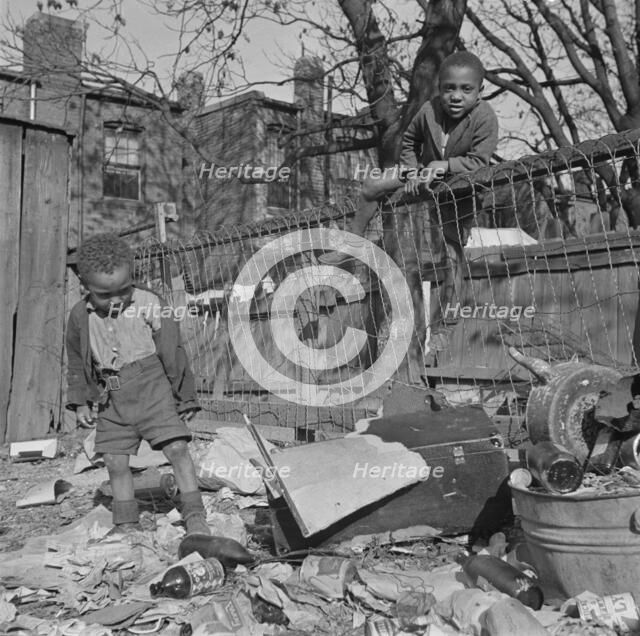 Two boys playing in their backyard, Washington (southwest section), D.C., 1942. Creator: Gordon Parks.