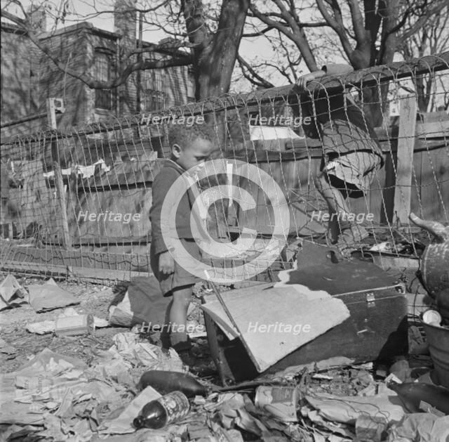 Two boys playing in their backyard, Washington (southwest section), D.C., 1942. Creator: Gordon Parks.