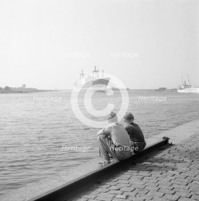 Two boys watching shipping in the harbour of Landskrona, Sweden, 1956. Creator: Unknown.