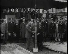Two British Men Guiding a Time Capsule Being Lowered in the Ground With Various Civilians..., 1938. Creator: British Pathe Ltd