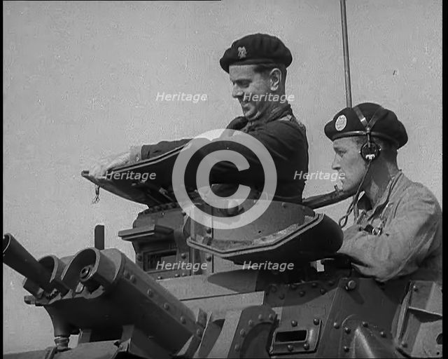 Two British Tank Operators Looking Out of a Tank Turret, 1940. Creator: British Pathe Ltd.