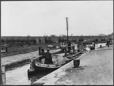 Two canal barges passing through a lock on the Grand Union Canal near Marsworth, Bucks, 1920-50. Creator: George R Long