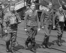 Two Captured German Pilots Being Escorted Away, 1940. Creator: British Pathe Ltd