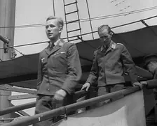 Two Captured German Pilots Being Escorted Down a Gangplank, 1940. Creator: British Pathe Ltd