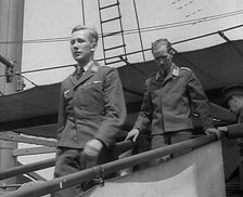 Two Captured German Pilots Being Escorted Down a Gangplank, 1940. Creator: British Pathe Ltd