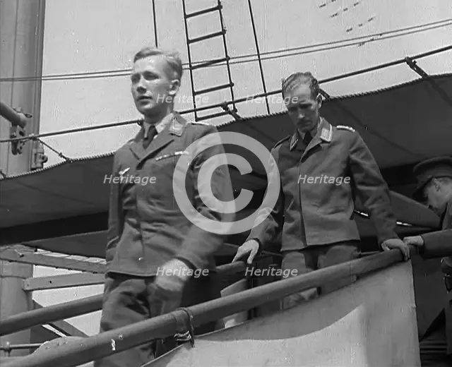 Two Captured German Pilots Being Escorted Down a Gangplank, 1940. Creator: British Pathe Ltd.