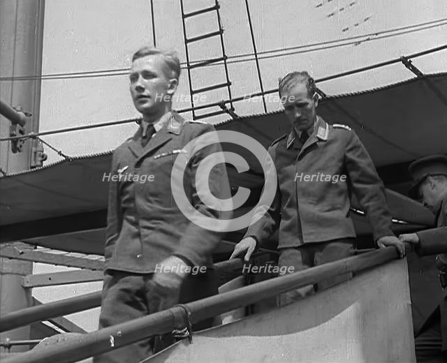 Two Captured German Pilots Being Escorted Down a Gangplank, 1940. Creator: British Pathe Ltd.