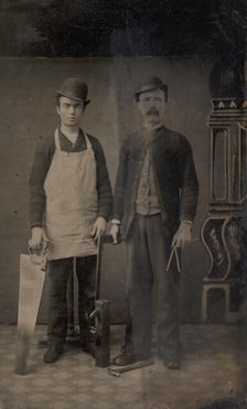 Two Carpenters with a Handsaw, Wood Plane, Hammer, Compass, and Square, 1880s. Creator: Unknown