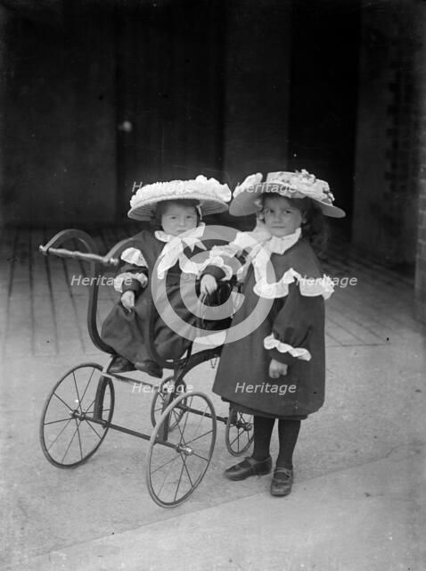 Two children and a pram, c1896-c1920. Artist: Alfred Newton & Sons