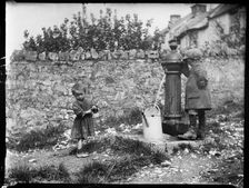 Two children collecting water at a water pump, Cheddar, Somerset, 1907. Creator: Katherine J Macfee