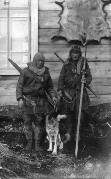 Two Chukchi in national clothes, with guns and a spear, 1910-1929. Creator: Ivan Emelianovich Larin