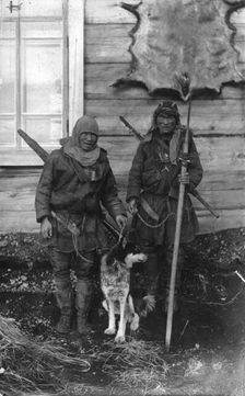 Two Chukchi in national clothes, with guns and a spear, 1910-1929. Creator: Ivan Emelianovich Larin
