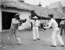 Two cock-fighters and referee at the World's Columbian Exposition, Chicago, Illinois, 1892 or 1893. Creator: Frances Benjamin Johnston