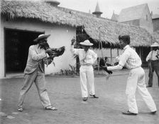 Two cock-fighters and referee at the World's Columbian Exposition, Chicago, Illinois, 1892 or 1893. Creator: Frances Benjamin Johnston