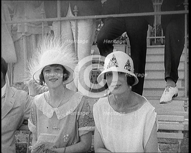 Two Female Civilians at a Horse Race Event Wearing Smart Summer Outfits and Hats, 1920. Creator: British Pathe Ltd.