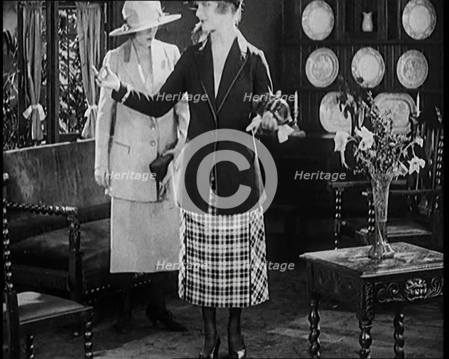 Two Female Civilians Modelling Two Piece Suits and Hats Posing in a Drawing Room, 1920. Creator: British Pathe Ltd.