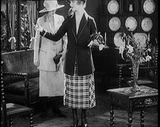 Two Female Civilians Modelling Two Piece Suits and Hats Posing in a Drawing Room, 1920. Creator: British Pathe Ltd