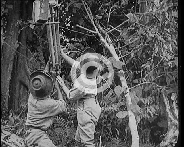 Two Female Civilians Wearing Explorers Outfit Setting up a Camera to Record Nature Life in..., 1920. Creator: British Pathe Ltd.
