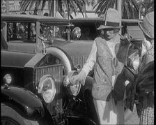 Two Female Civilians Wearing Glamorous Outfits Admiring a Luxurious Car, 1920. Creator: British Pathe Ltd