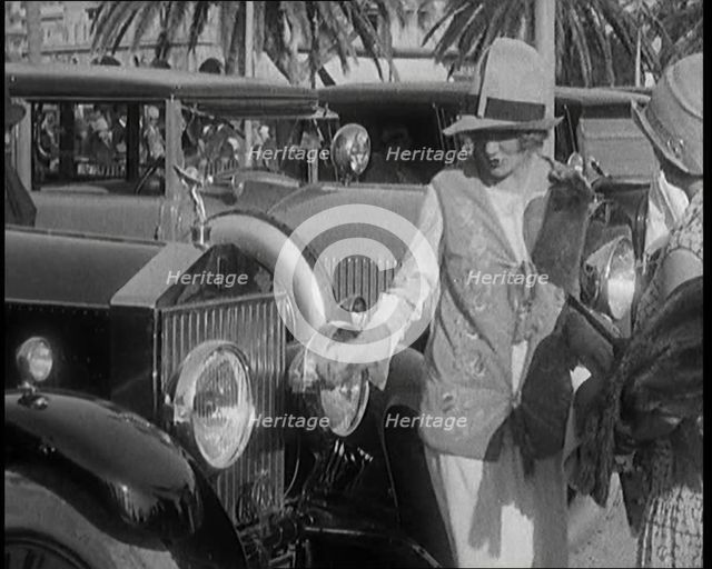 Two Female Civilians Wearing Glamorous Outfits Admiring a Luxurious Car, 1920. Creator: British Pathe Ltd.