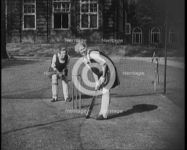 Two Female Civilians Wearing Gymslips and Batting Pads Preparing to Bat in a Playing Field, 1920. Creator: British Pathe Ltd.