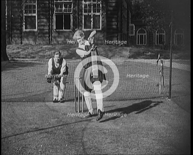 Two Female Civilians Wearing Gymslips and Batting Pads Preparing to Bat in a Playing Field, 1920. Creator: British Pathe Ltd.