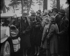 Two Female Civilians Wearing Heavy Coats and Hats Embarquing a Luggage Loaded Car Watched by...,1920 Creator: British Pathe Ltd