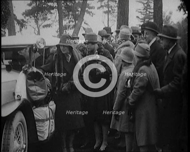 Two Female Civilians Wearing Heavy Coats and Hats Embarquing a Luggage Loaded Car Watched by...,1920 Creator: British Pathe Ltd.