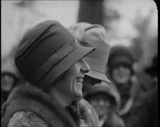 Two Female Civilians Wearing Heavy Coats and Hats Standing in Front of a Car, 1920. Creator: British Pathe Ltd