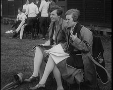 Two Female Civilians Wearing School Uniforms Taking Notes on a Notepad on the Side of a..., 1920. Creator: British Pathe Ltd