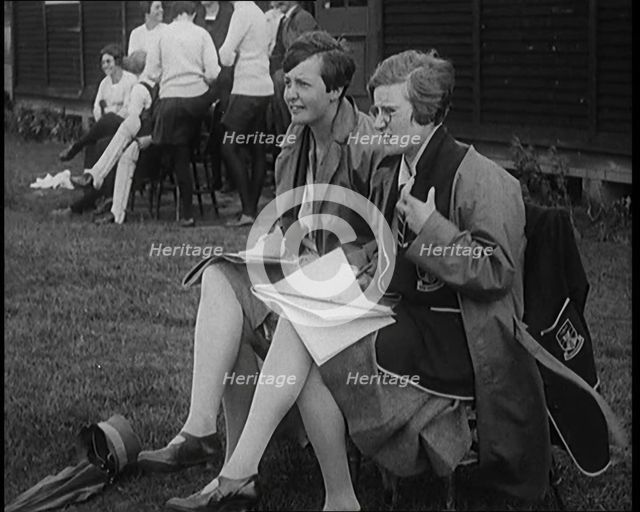 Two Female Civilians Wearing School Uniforms Taking Notes on a Notepad on the Side of a..., 1920. Creator: British Pathe Ltd.