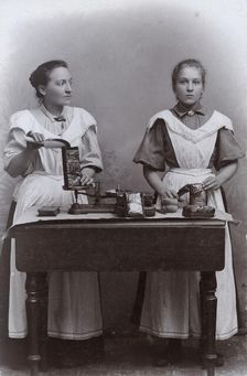 Two girls measuring coffee at the Dutch coffee shop, Landskrona, Sweden, 1910