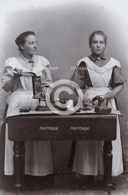 Two girls measuring coffee at the Dutch coffee shop, Landskrona, Sweden, 1910. Artist: Unknown