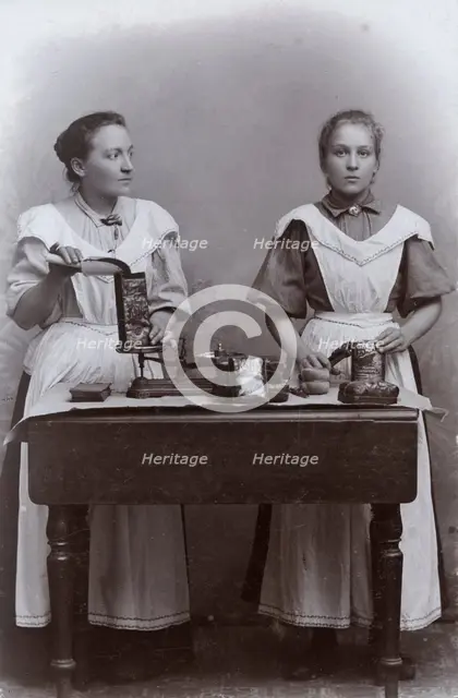 Two girls measuring coffee at the Dutch coffee shop, Landskrona, Sweden, 1910. Creator: Unknown.