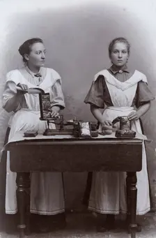 Two girls measuring coffee at the Dutch coffee shop, Landskrona, Sweden, 1910. Creator: Unknown