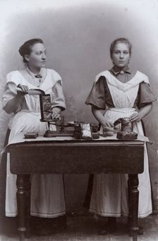 Two girls measuring coffee at the Dutch coffee shop, Landskrona, Sweden, 1910. Creator: Unknown
