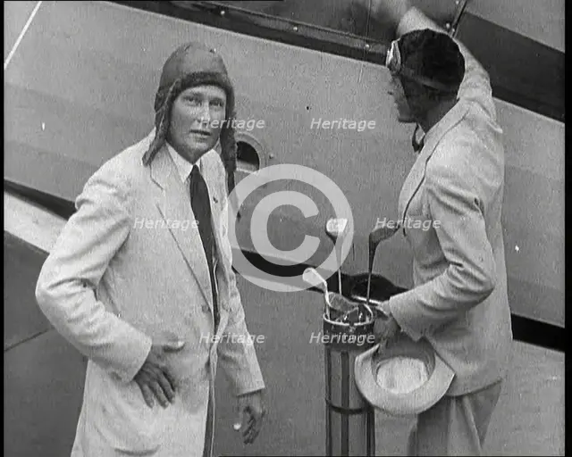 Two Golfers With Gold Clubs Enter a Gyrocopter, 1932. Creator: British Pathe Ltd.