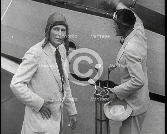 Two Golfers With Gold Clubs Enter a Gyrocopter, 1932. Creator: British Pathe Ltd.
