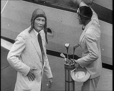 Two Golfers With Gold Clubs Enter a Gyrocopter, 1932. Creator: British Pathe Ltd