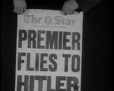 Two Hands Holding the Star Newspaper Headline PREMIER FLIES TO HITLER 1938. Creator: British Pathe Ltd