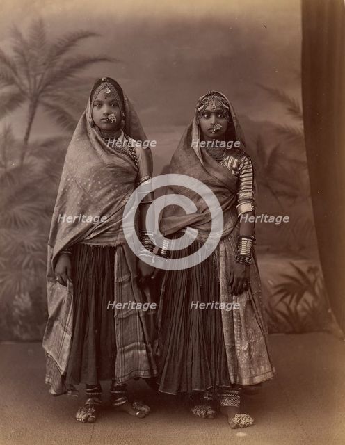 Two Hindu Women in Elaborate Jewelry, Before Studio Backdrop with Palm Trees, 1860s-70s. Creator: Unknown.
