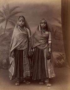 Two Hindu Women in Elaborate Jewelry, Before Studio Backdrop with Palm Trees, 1860s-70s. Creator: Unknown